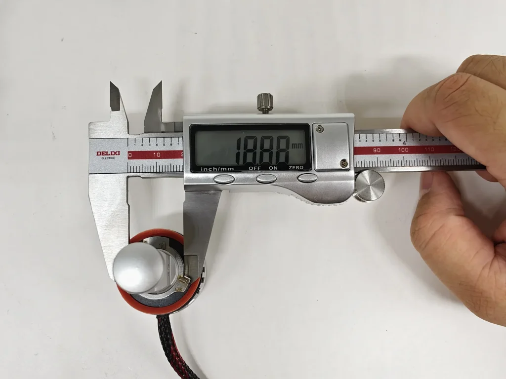 Outer-diameter measurement of the EB H11 LEDr base locating section with the digital caliper reading oriented for normal reading